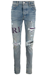 AMIRI Purple Serif Logo Distressed Skinny Jeans